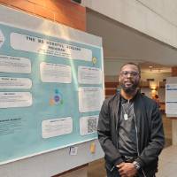 Terrence Bolden standing in front of his poster presentation